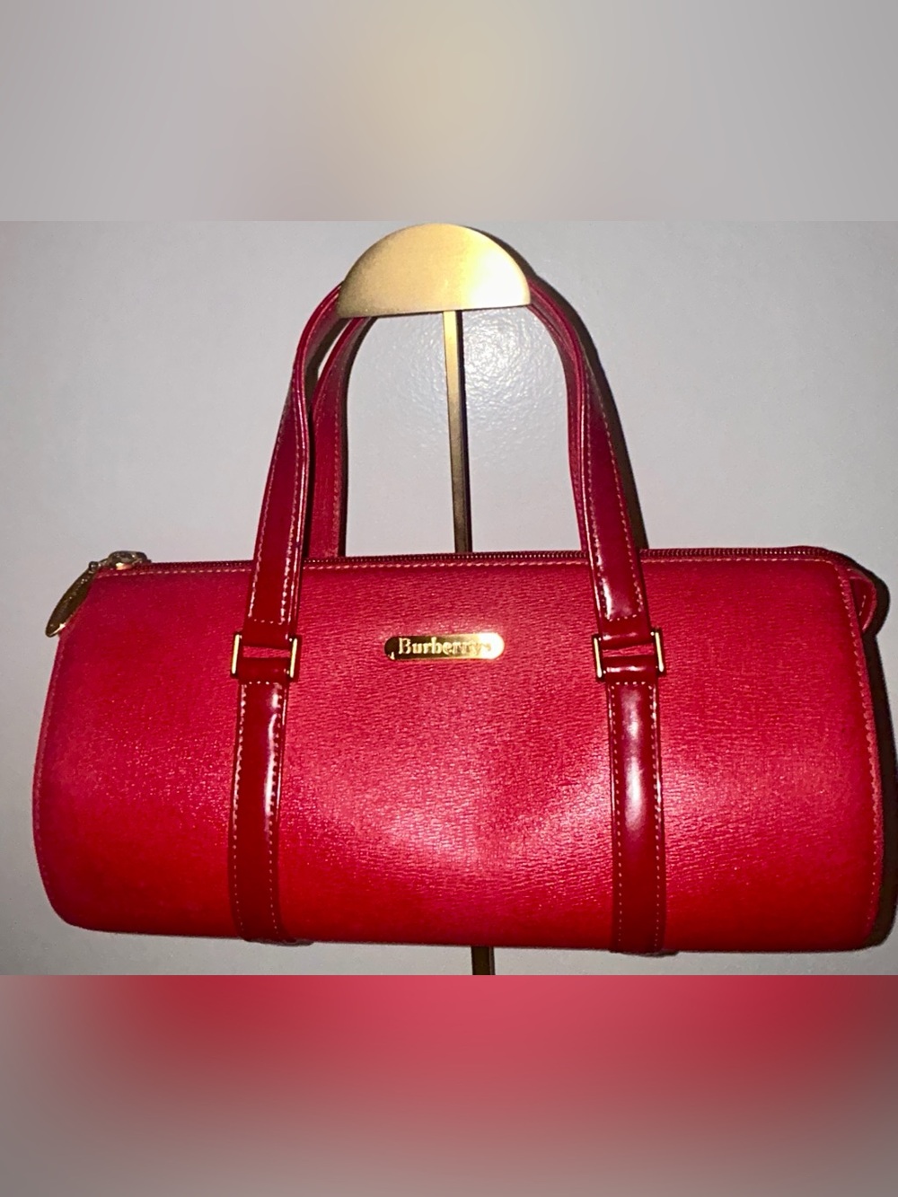 Burberrys Red Leather Barrel Shoulder Bag with Gold-Tone Plaque. COA included.